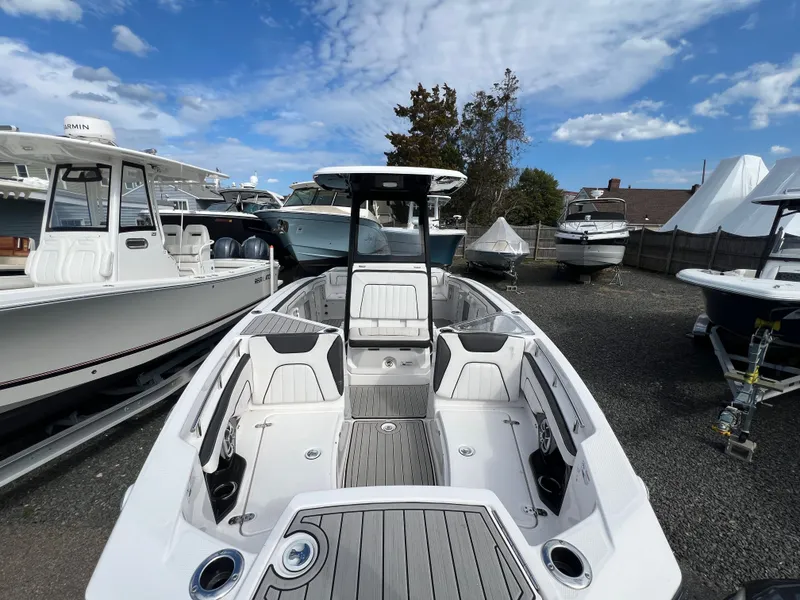Slide: The Image of 2023 Yamaha Boats 255 FSH Sport E in a marina. - 6