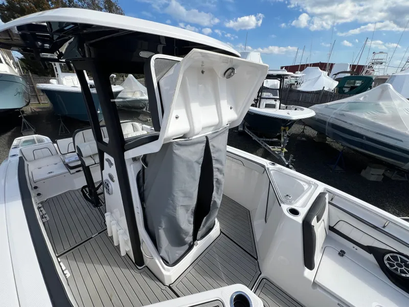 Slide: The Image of Yamaha Boats 255 FSH Sport E 2023 with open storage compartment. - 9