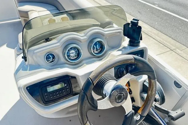 Slide: The Image of Steering console of 2016 Avalon LSV Tri Toon boat with gauges and controls. - 6