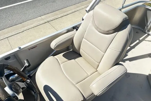Slide: The Image of 2016 Avalon LSV Tri Toon boat captain's chair, beige leather, near steering wheel. - 7