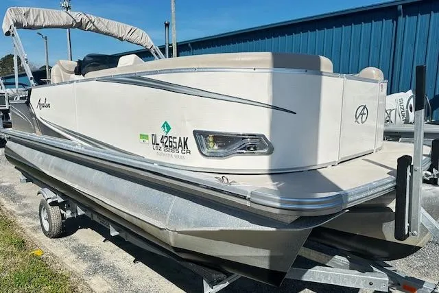The Image of 2016 Avalon LSV Tri Toon boat on trailer, parked outdoors. - 0