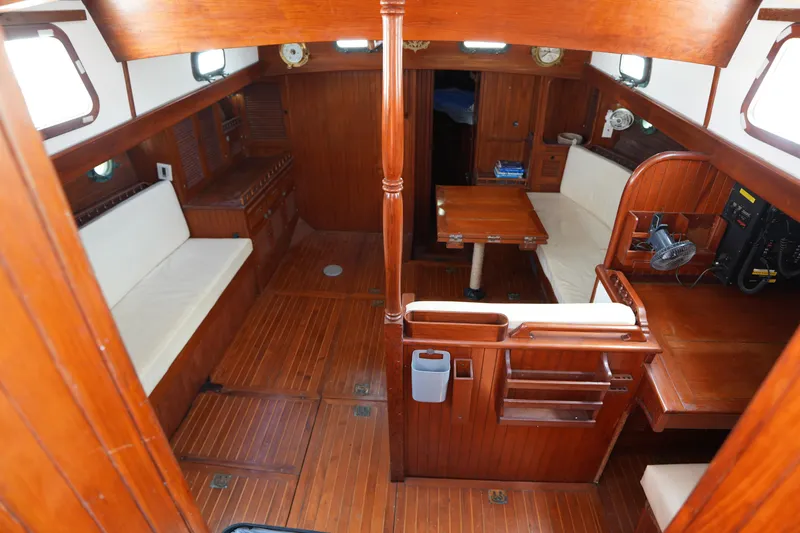 Slide: The Image of Interior of 1982 Vagabond 47 sailboat with wooden furnishings and seating area. - 19