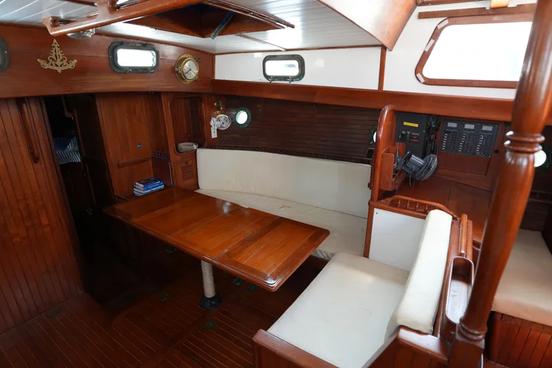 Slide: The Image of Interior of 1982 Vagabond 47 sailboat with wooden furnishings and seating area. - 20