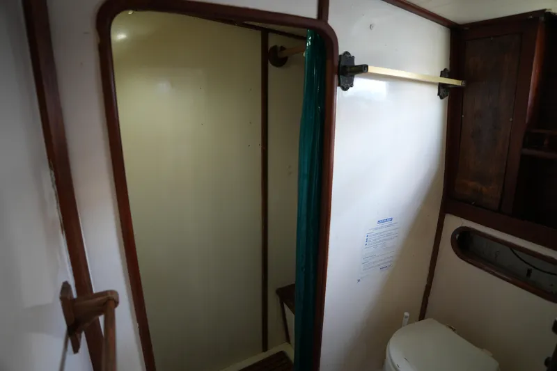 Slide: The Image of Interior of 1982 Vagabond 47 sailboat bathroom with shower and toilet. - 38