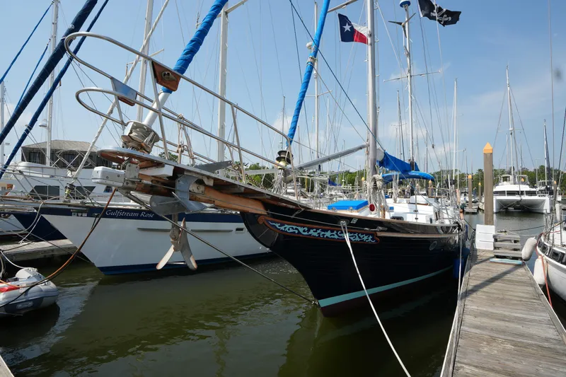 Slide: The Image of Sailboat docked at marina, Vagabond 47 model, 1982, with nautical flags. - 6