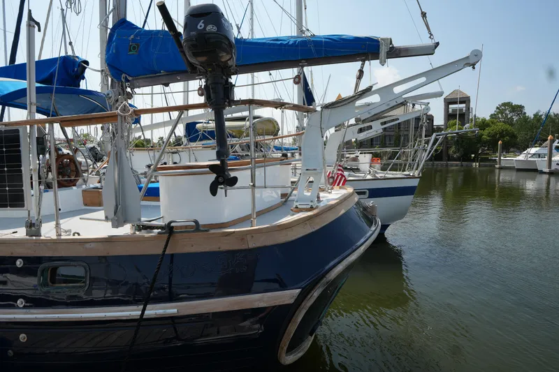 Slide: The Image of 1982 Vagabond 47 sailboat docked in a marina, featuring blue and white design. - 8