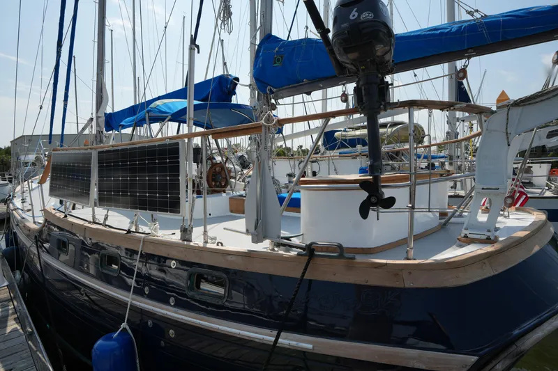 Slide: The Image of 1982 Vagabond 47 sailboat with solar panels docked at marina. - 9