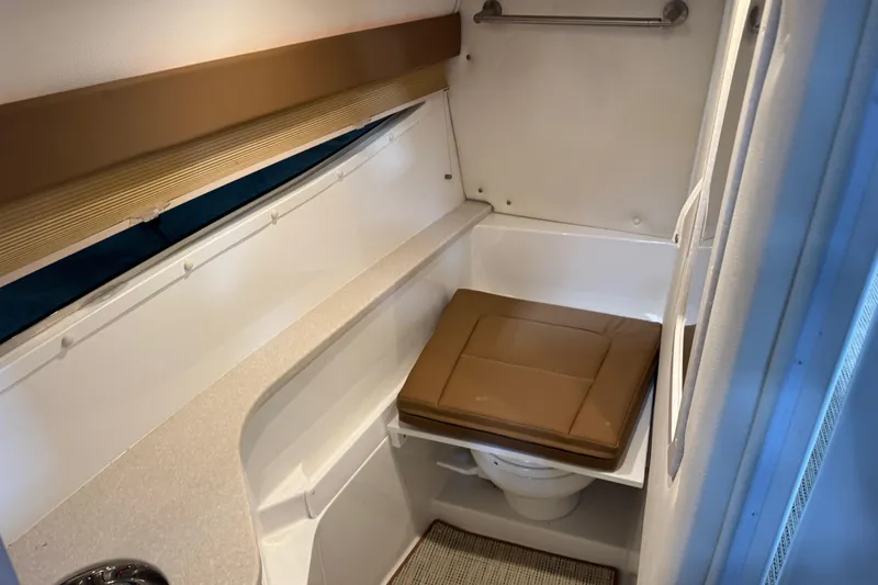Slide: The Image of Compact bathroom in 2019 Cobalt R35 boat with cushioned seat and modern fixtures. - 14