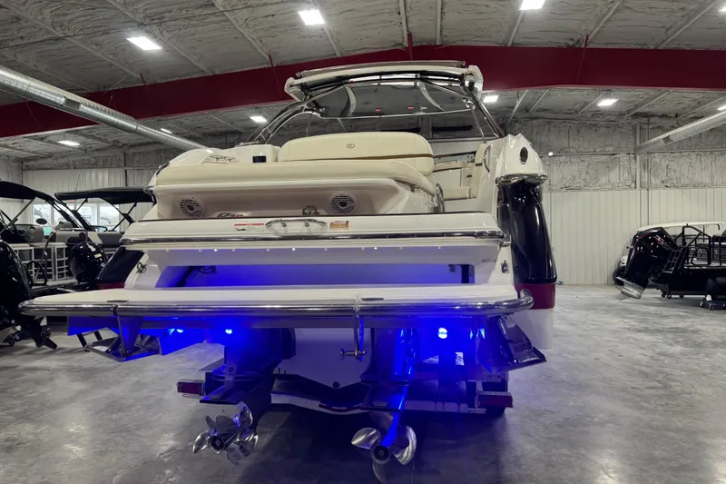 Slide: The Image of 2019 Cobalt R35 boat in showroom with illuminated blue lights and dual propellers. - 5