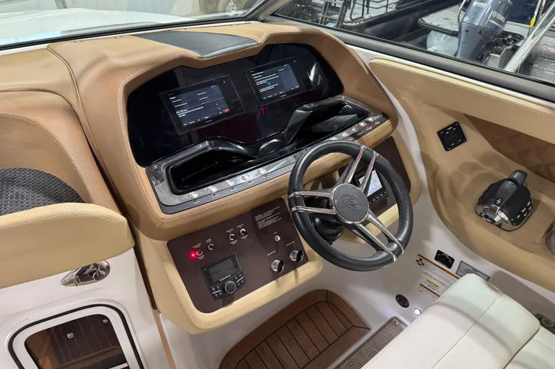 Slide: The Image of 2019 Cobalt R35 boat dashboard with steering wheel, dual screens, and control panel. - 9