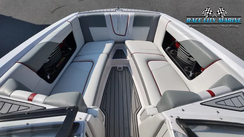 Slide: The Image of The image shows the bow area of a 2013 Nautique G23 with gray and white upholstery. - 41