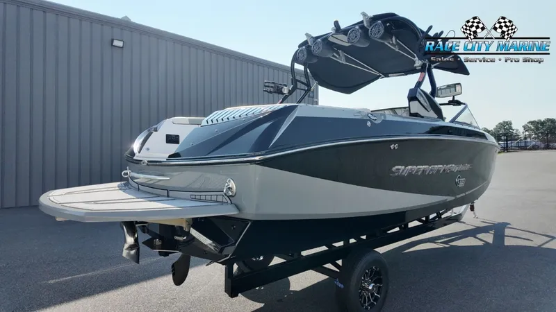 Slide: The Image of A 2013 Nautique G23 boat on a trailer, featuring a sleek design and a tower. - 8