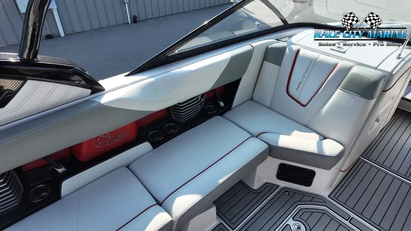 Slide: The Image of The image shows the interior of a 2013 Nautique G23 boat with gray and white seating. - 21