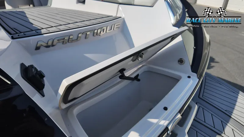 Slide: The Image of The image shows the storage compartment of a 2013 Nautique G23 boat with an open hatch. - 12