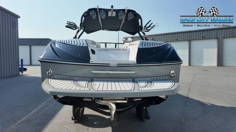 Slide: The Image of A 2013 Nautique G23 boat is on a trailer in a storage area. - 4