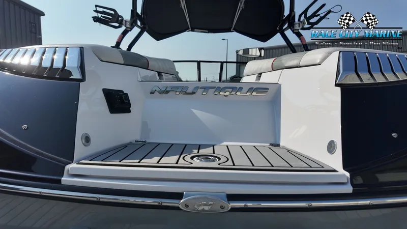 Slide: The Image of The image shows the stern of a 2013 Nautique G23 boat with sleek design. - 13