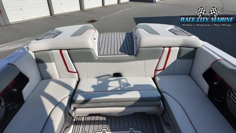 Slide: The Image of The image shows the stern of a 2013 Nautique G23 boat with gray and white upholstery. - 15