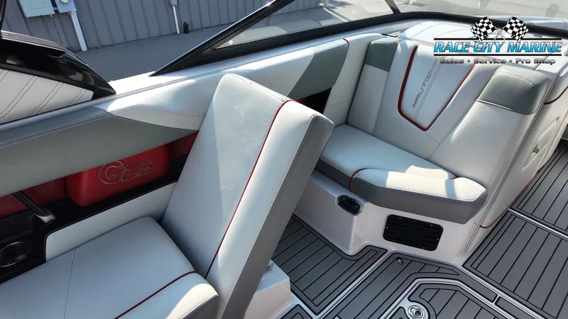 Slide: The Image of Interior of a 2013 Nautique G23 with gray and red accents, luxurious seating, and modern design. - 31