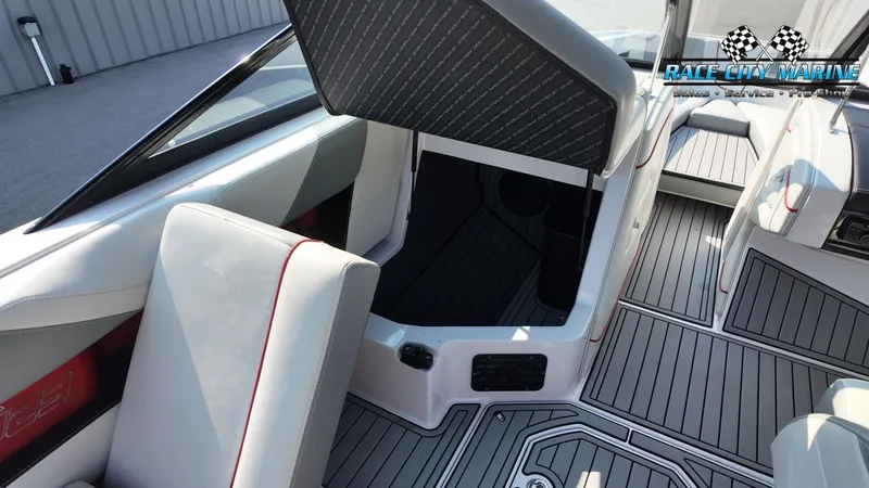 Slide: The Image of The image shows the interior of a 2013 Nautique G23 boat with gray upholstery. - 43