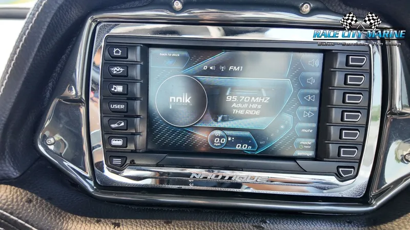 Slide: The Image of The image shows a modern dashboard with a digital display in a Nautique G23 boat. - 47