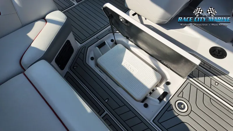 Slide: The Image of The image shows the interior of a 2013 Nautique G23 with an open storage compartment. - 25