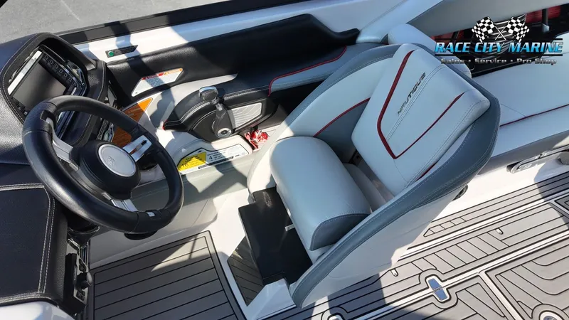Slide: The Image of The image shows the interior of a 2013 Nautique G23 with a sleek, modern cockpit. - 23