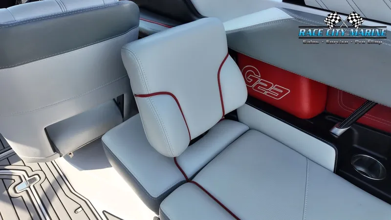 Slide: The Image of Interior of a 2013 Nautique G23 with gray and red seating. - 19