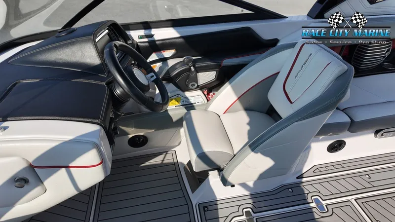 Slide: The Image of The image shows the cockpit of a 2013 Nautique G23 with a sleek steering wheel and modern seating. - 49