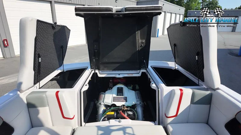 Slide: The Image of The 2013 Nautique G23 displays its engine compartment with open hatches in a warehouse. - 22