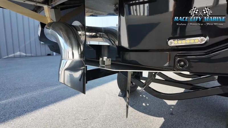 Slide: The Image of Close-up of a 2013 Nautique G23's stern with stainless steel components and an LED light. - 10