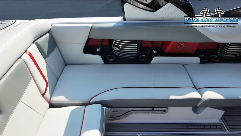 Slide: The Image of The image shows the interior of a 2013 Nautique G23 boat with gray and red seating. - 17