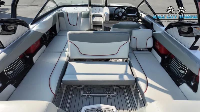 Slide: The Image of The image shows the interior of a 2013 Nautique G23 boat with gray and white seating. - 28