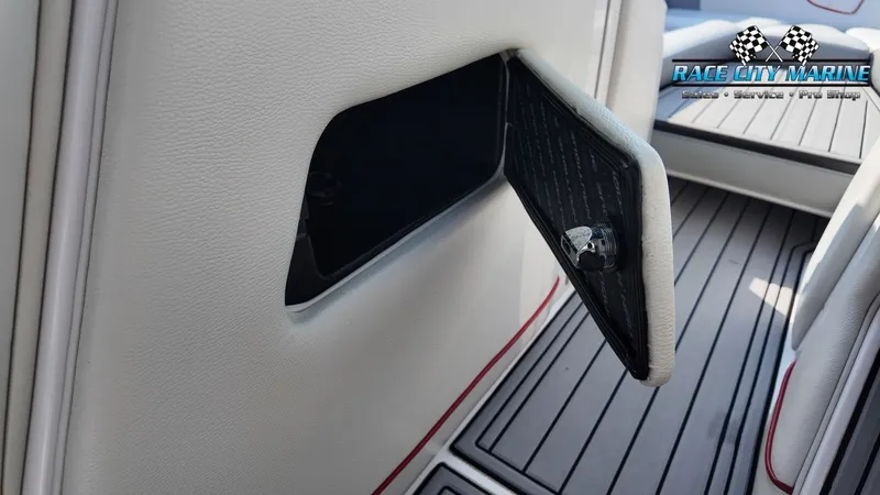 Slide: The Image of An open storage compartment inside a boat with gray flooring. - 18