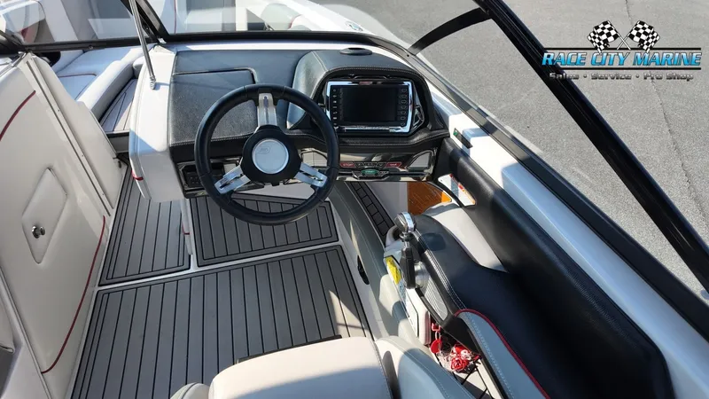 Slide: The Image of The image shows the cockpit of a 2013 Nautique G23 boat with modern controls. - 30