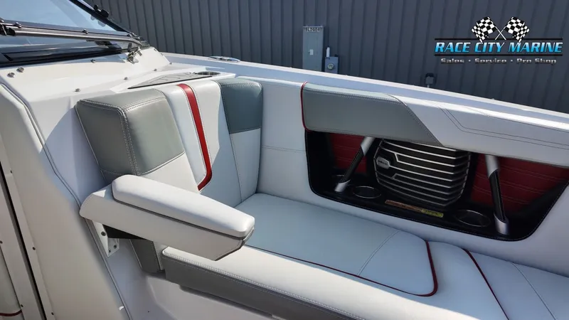 Slide: The Image of The image shows the gray and white upholstery of a 2013 Nautique G23 with red accents. - 16