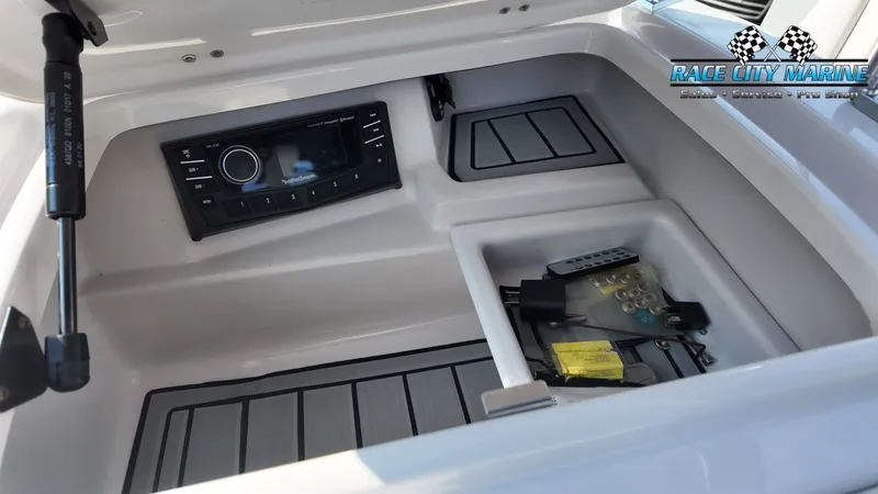 Slide: The Image of The image shows an open storage compartment with a built-in audio system and accessories. - 37