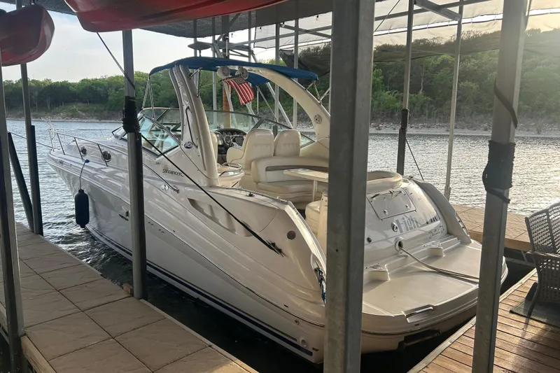 The Image of 2003 Sea Ray 340 Sundancer docked at a serene lakeside marina. - 0