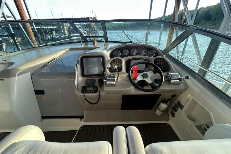 Slide: The Image of 2003 Sea Ray 340 Sundancer helm with steering wheel, gauges, and navigation equipment. - 12