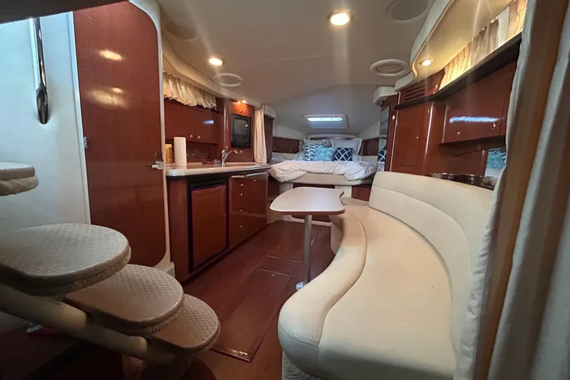 Slide: The Image of Luxurious interior of 2003 Sea Ray 340 Sundancer yacht with cozy seating and kitchenette. - 14