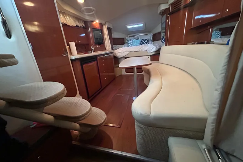 Slide: The Image of Luxurious interior of 2003 Sea Ray 340 Sundancer yacht with elegant seating and kitchenette. - 15