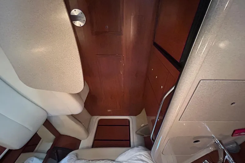 Slide: The Image of Interior of a 2003 Sea Ray 340 Sundancer boat, featuring wood paneling and seating. - 16