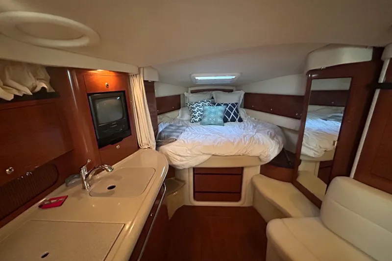 Slide: The Image of Luxurious cabin interior of 2003 Sea Ray 340 Sundancer with cozy bed and kitchenette. - 17