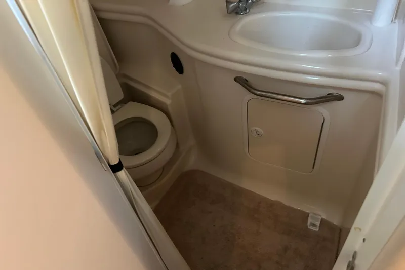 Slide: The Image of 2003 Sea Ray 340 Sundancer bathroom with toilet and sink. - 21