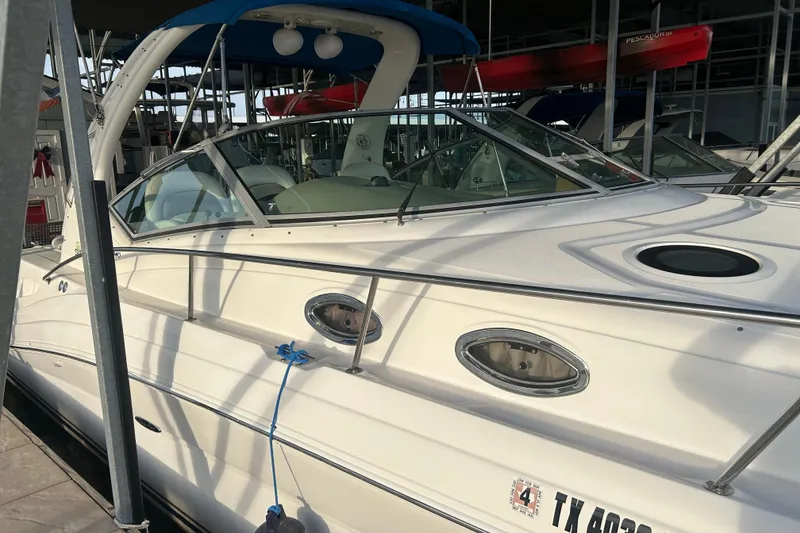 Slide: The Image of 2003 Sea Ray 340 Sundancer docked in marina, side view with visible registration. - 4