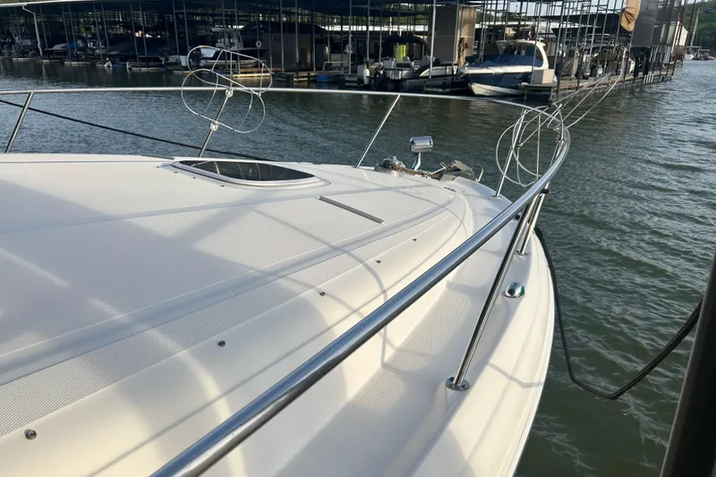 Slide: The Image of 2003 Sea Ray 340 Sundancer yacht docked at marina, showcasing sleek deck design. - 7