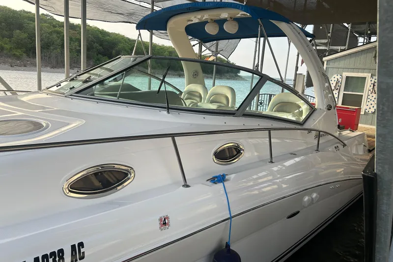 Slide: The Image of 2003 Sea Ray 340 Sundancer docked, featuring sleek design and luxurious seating. - 8