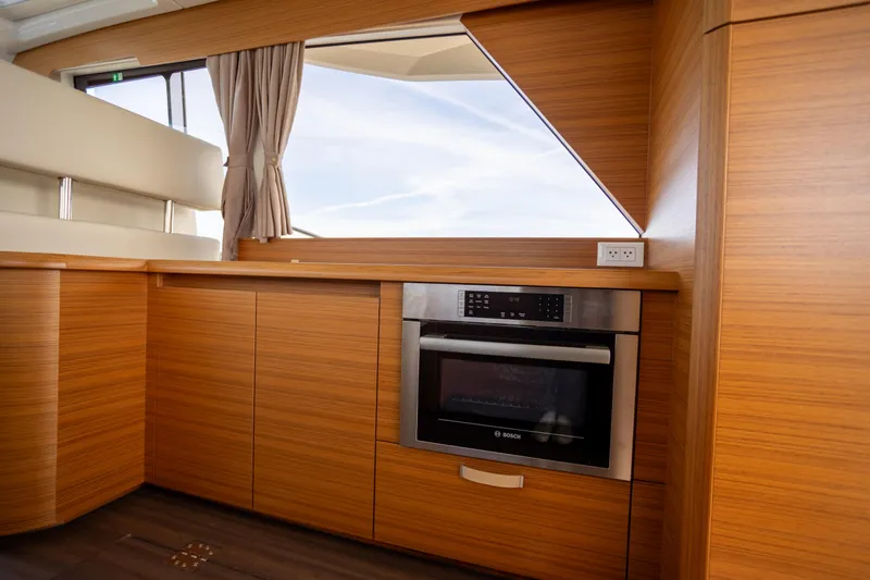 Slide: The Image of Modern kitchen interior of 2024 Greenline 39 yacht with wood finish and built-in oven. - 10