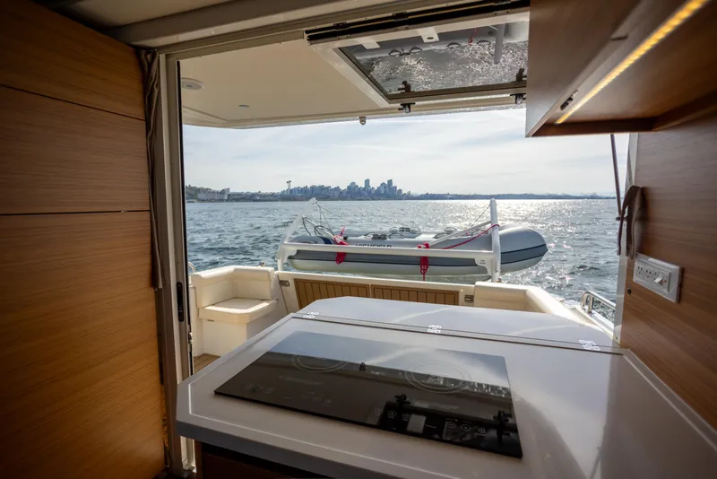 Slide: The Image of Interior view of 2024 Greenline 39 yacht with city skyline and ocean backdrop. - 12