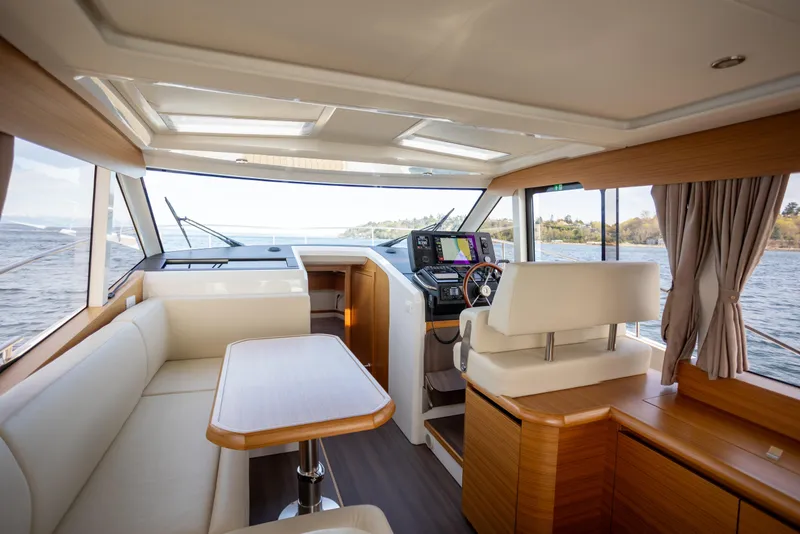 Slide: The Image of Interior of 2024 Greenline 39 yacht with modern helm, seating, and panoramic windows. - 13