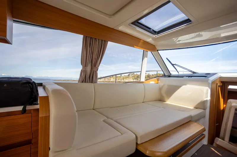 Slide: The Image of Interior of 2024 Greenline 39 yacht with white seating and panoramic windows. - 15